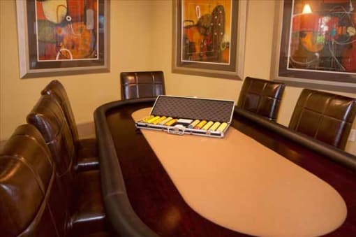 a conference room with leather chairs and a wooden conference table