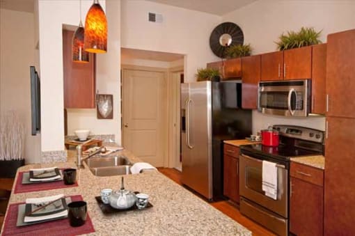 a kitchen with stainless steel appliances and granite counter tops