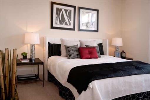 a bedroom with a bed and two pictures on the wall