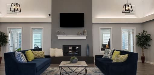 a living room with blue couches and a fireplace