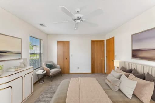 a living room with a couch and a ceiling fan