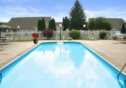 a swimming pool with a white fence around it