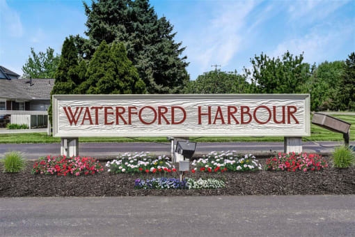 a sign for waterford harbour in front of flowers