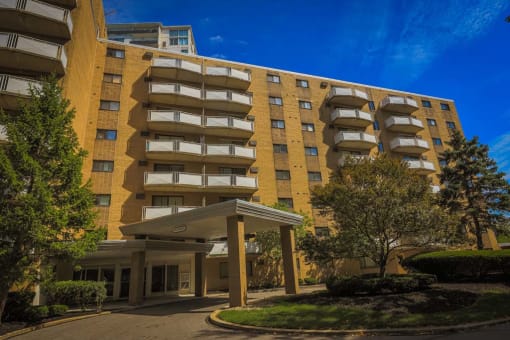 a large apartment building with trees in front of it