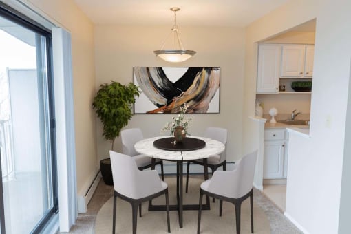 a dining room with a table and chairs