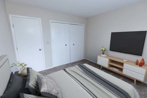 a bedroom with a bed and a television