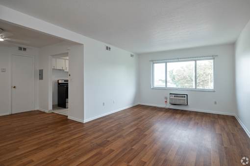 A room with wooden floors and a window.