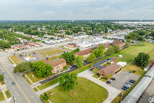 A small town with a lot of greenery and buildings.