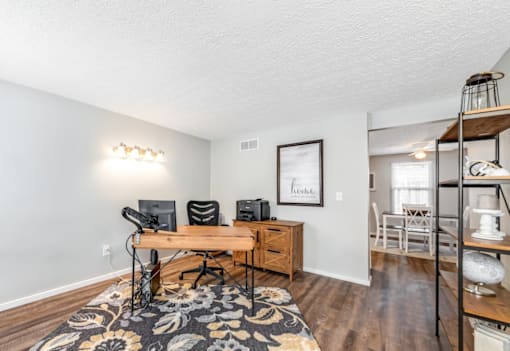 A room with a desk and a chair in it.