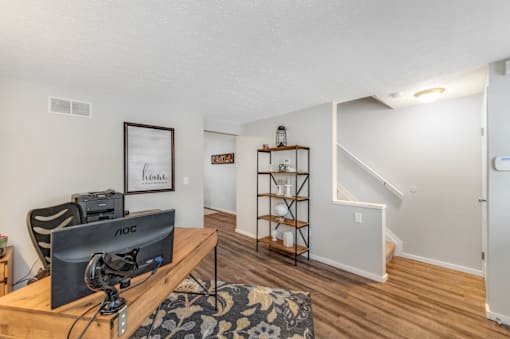 A room with a TV and a chair.