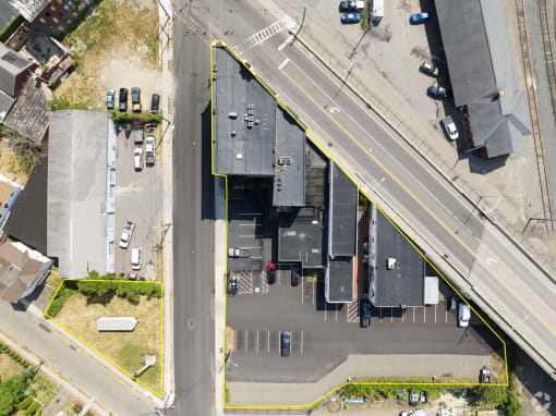an aerial view of a parking lot and a building