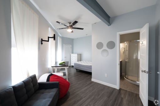 a living room with a couch and a ceiling fan