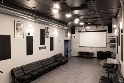 a large room with couches and a projection screen