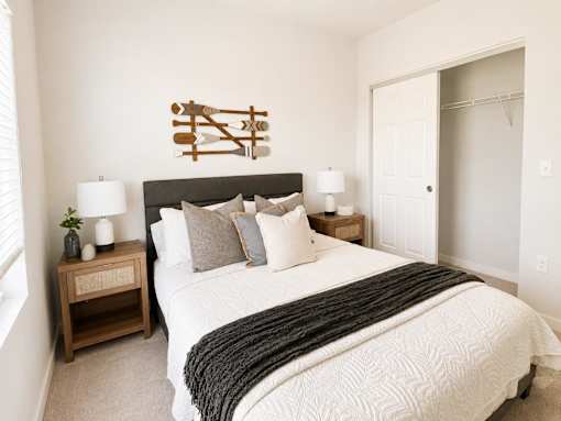A bedroom with a large bed and a wooden headboard.