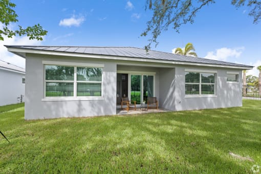 a white house with a lawn and a porch