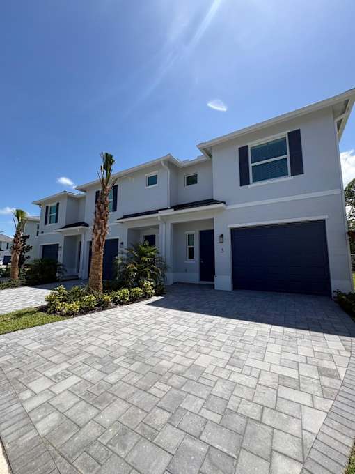 A modern house with a driveway in front.