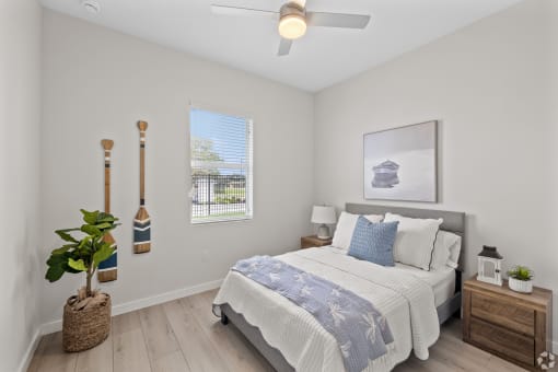 a bedroom with a bed and a ceiling fan