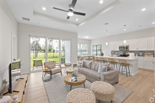 a living room with a couch and a kitchen with a table and chairs