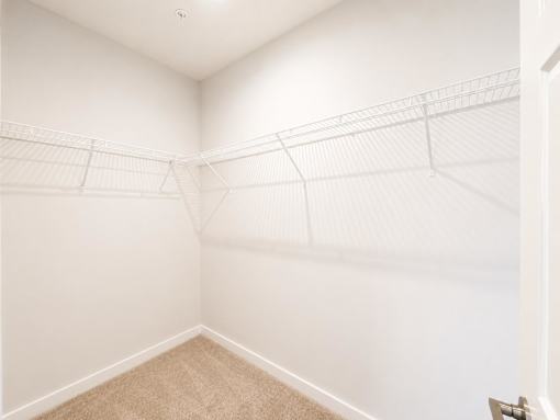 A room with white walls and a carpeted floor.
