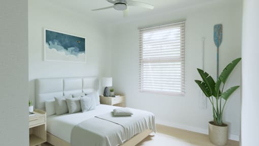 A bedroom with a bed, a ceiling fan, a nightstand with a lamp, a potted plant, and a painting on the wall.