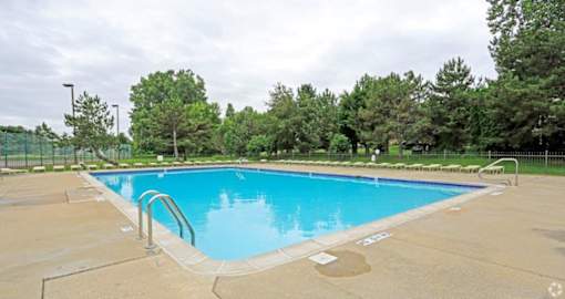 a blue swimming pool with a fence around it