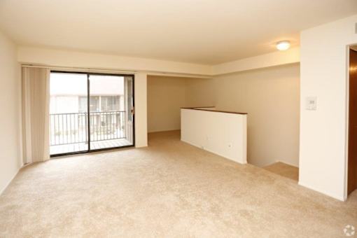 an empty living room with a sliding glass door