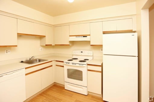 a kitchen with white appliances and white cabinets