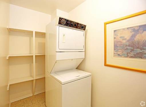 a white closet with white shelves and a white oven