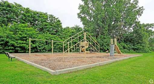 a playground with a swing set in a park