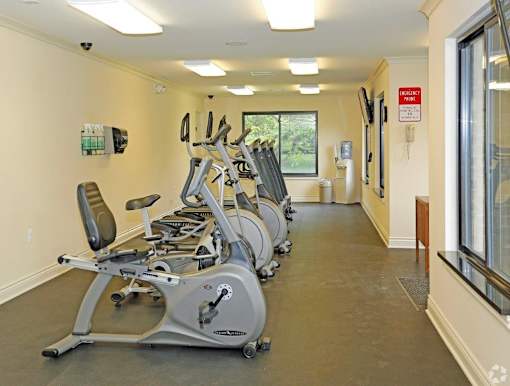 a gym full of cardio equipment in a building