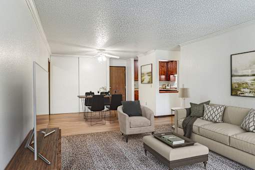 a living room with a couch and a chair and a dining room at Pheasant Park Apartments, Minnesota, 55428-5401
