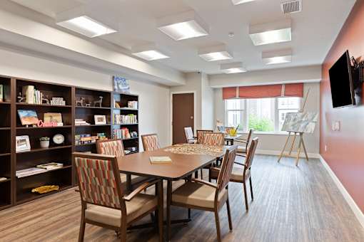 A dining room with a table and chairs at Sonder Point 50+ Apartments, Brooklyn Center, MN