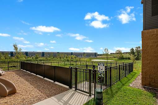 A playground with a black fence and a signboard is visible.