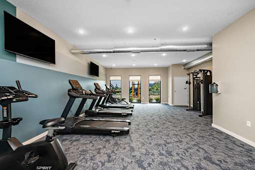 A gym with treadmills and exercise bikes.