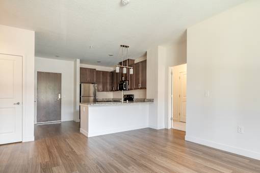 a kitchen and living room with hardwood floors and white walls at Sonder House, Brooklyn Center, MN, 55430