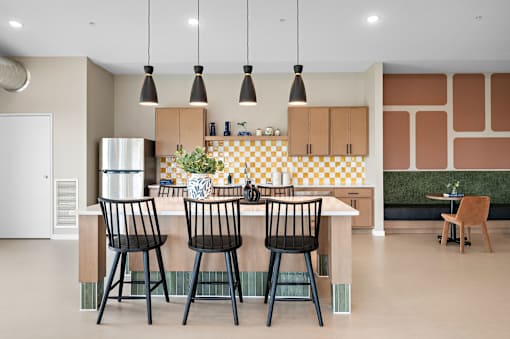 A kitchen with a table and chairs.