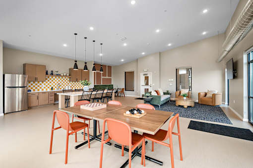 A modern dining room with a wooden table and chairs.