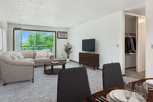 a living room and dining room with a couch and a tv at Pheasant Park Apartments, Minnesota