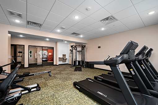 A gym with treadmills and exercise equipment.at Decatur Landing I & II, Brooklyn Park, MN