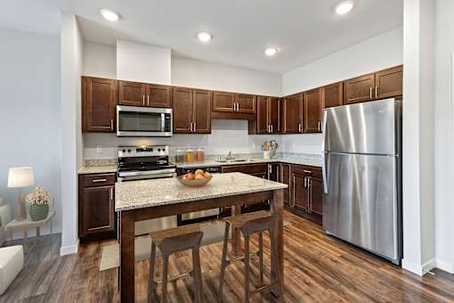 a kitchen with stainless steel appliances and a granite counter top at EastGate Apartments, Rochester, MN