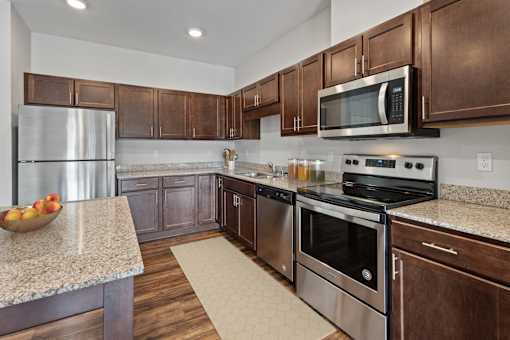 a kitchen with stainless steel appliances and granite counter tops at EastGate Apartments, Rochester, MN
