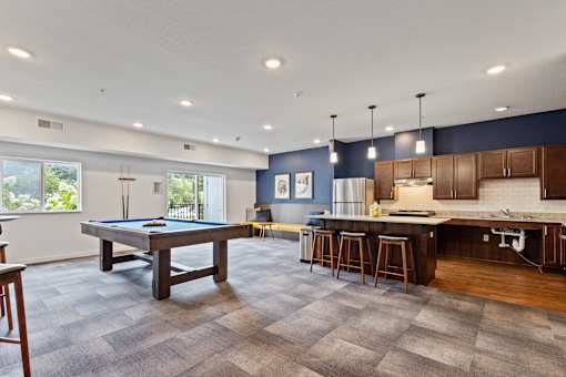 a game room with a pool table and a kitchen at EastGate Apartments, Rochester, MN, 55904
