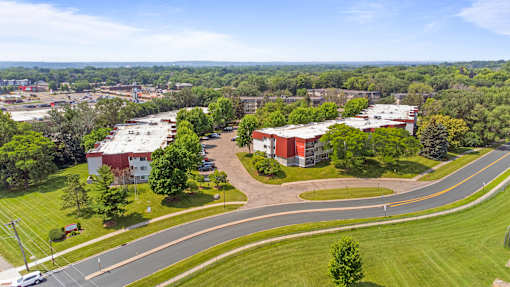 an aerial view of a campus with buildings and a road at Heritage Hills Apartments, Minnesota, 55437
