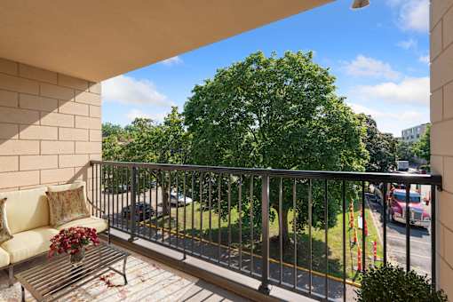 a balcony with a couch and a tree at Humboldt Senior 55+ Apartments, Minnesota, 55107