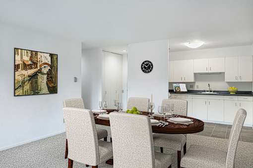 a dining room with a table and chairs and a kitchen at Humboldt Senior 55+ Apartments, Saint Paul, MN, 55107