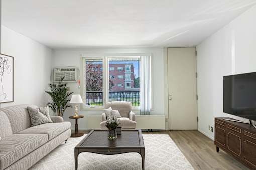 a living room with a couch and a coffee table at Humboldt Senior 55+ Apartments, Saint Paul