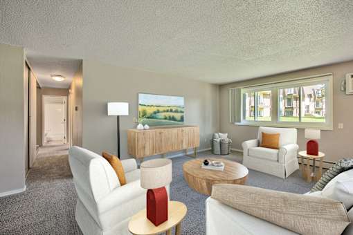 A living room with a white couch, a red lamp, and a painting on the wall at Northtown Village Apartments, Minnesota