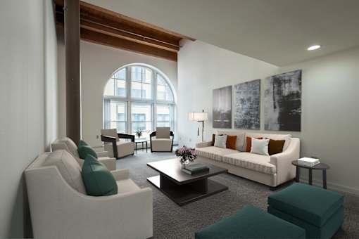 a living room with white furniture and a large arched window at Parkside Apartments, St. Paul, Minnesota