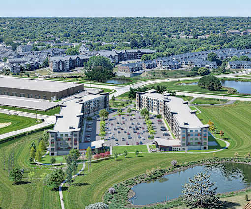 A large building complex with a parking lot in front and a pond in the foreground.