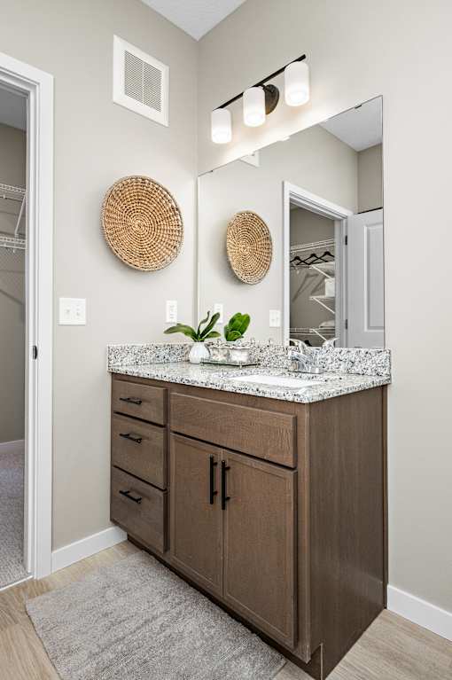 A bathroom with a vanity and a mirror.